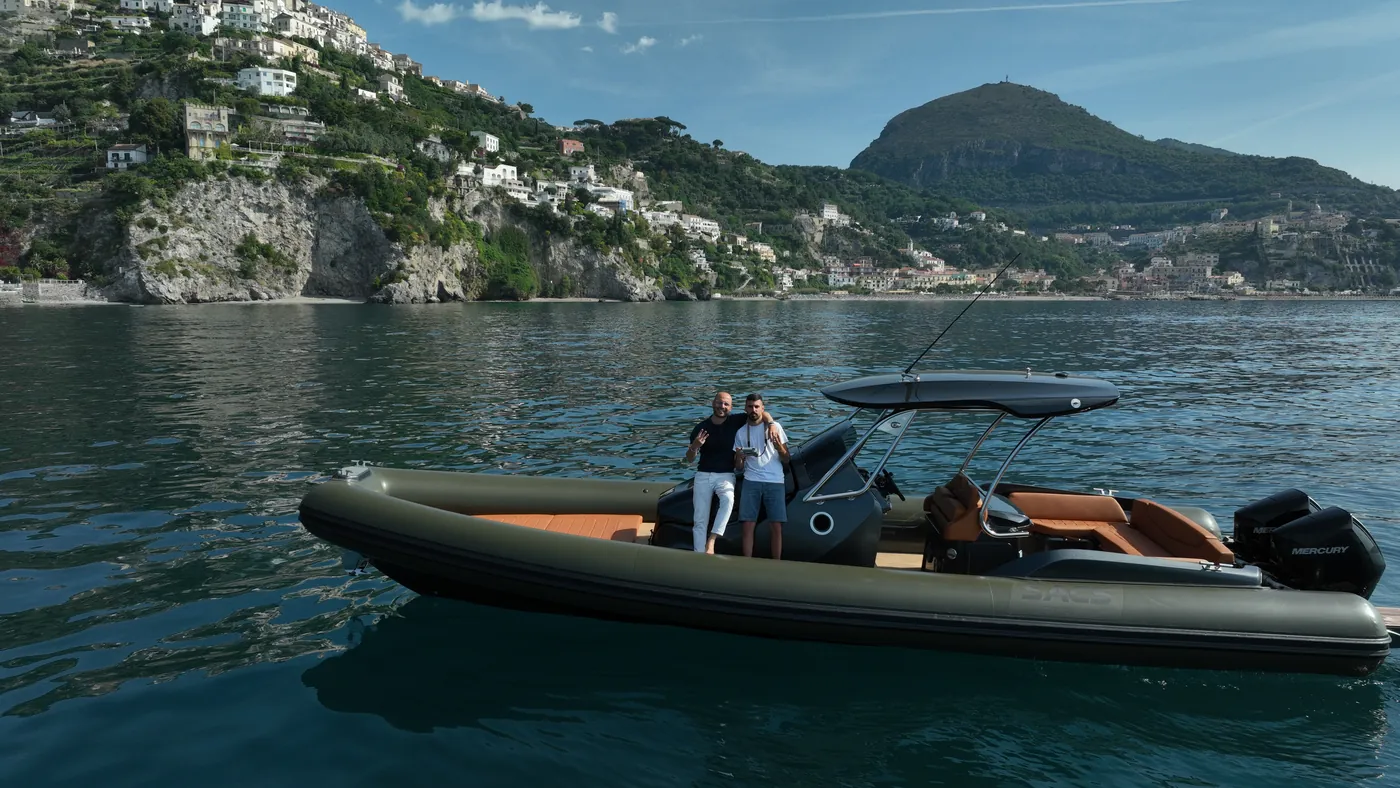 Procida from the sea: Corricella, coves and clear water